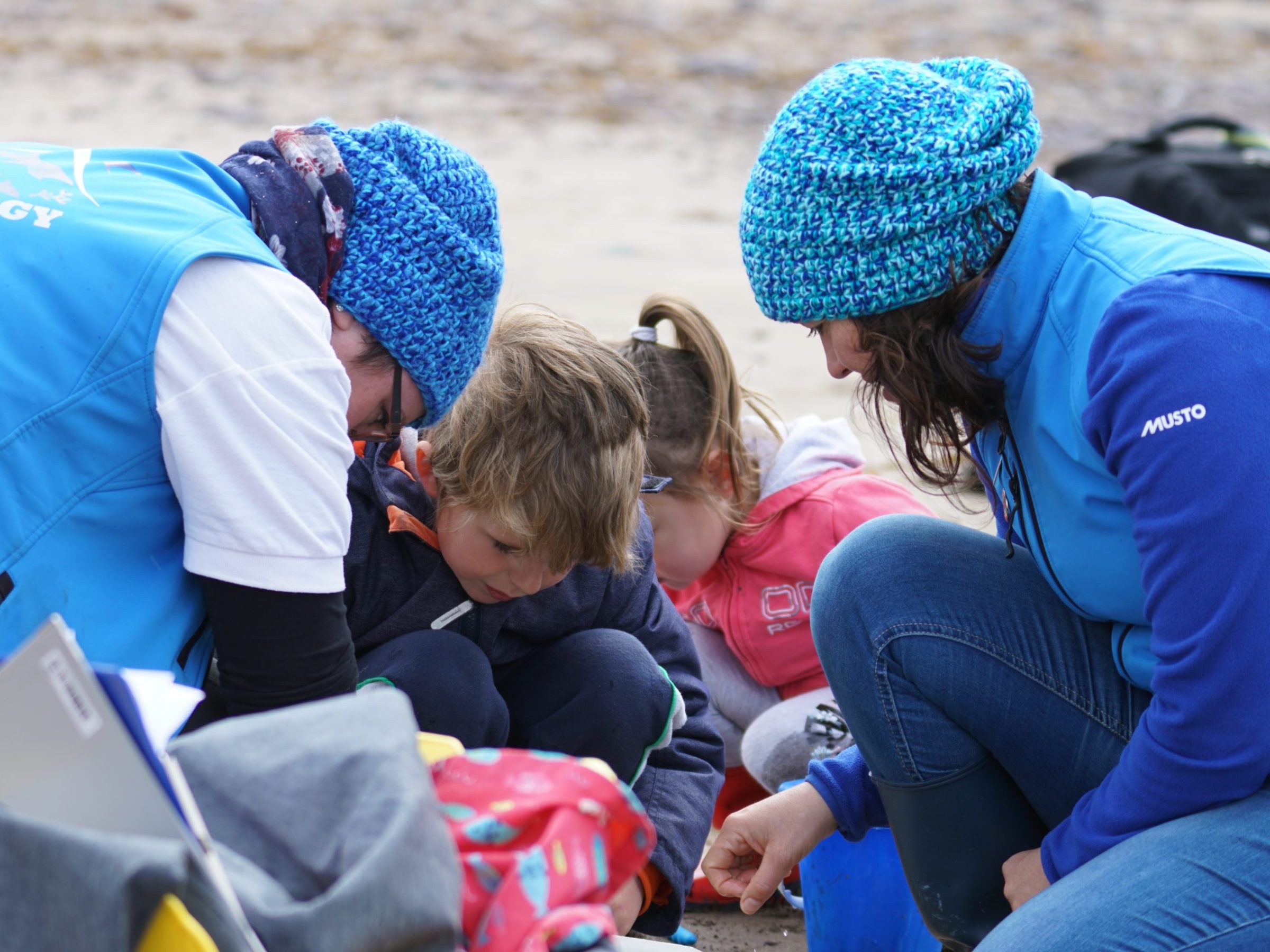 a group of people sitting next to a child