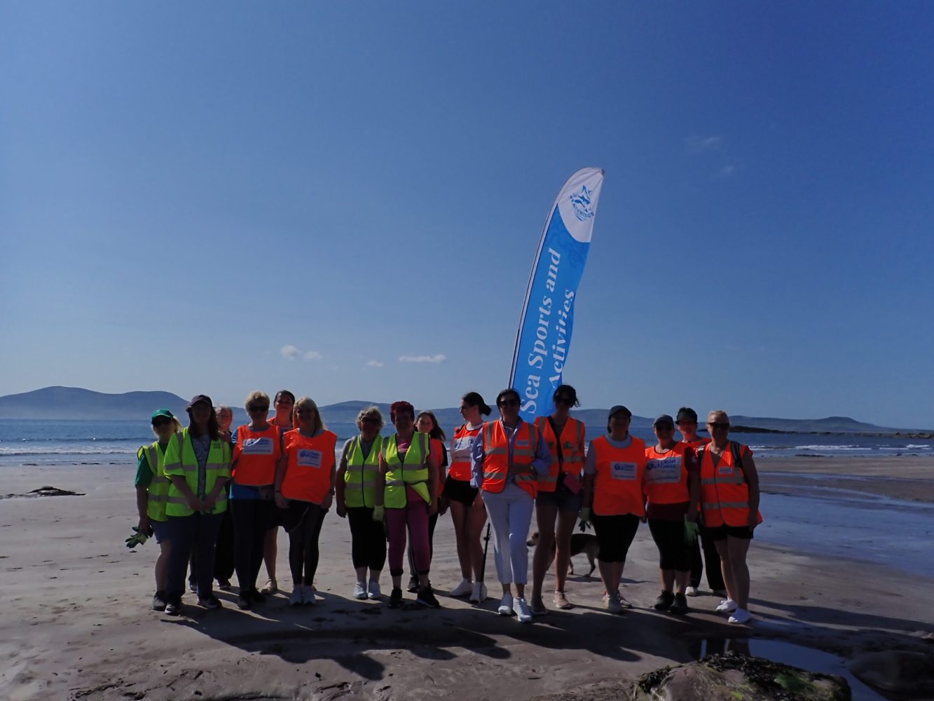 a group of people on a beach posing for the camera